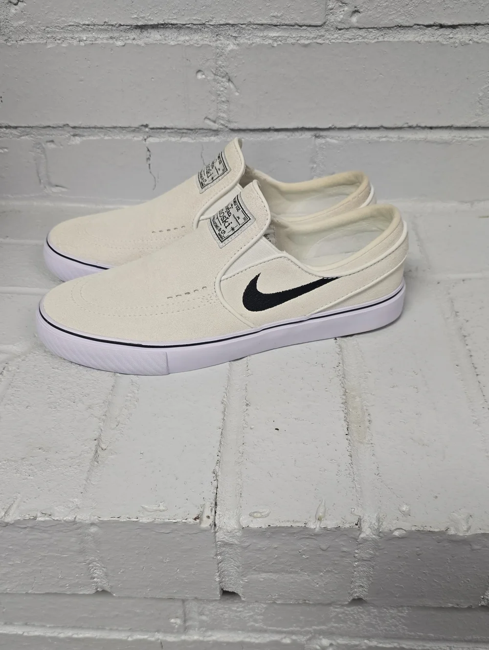 Nike Slip-On Sneakers in Off-White with Black Swoosh